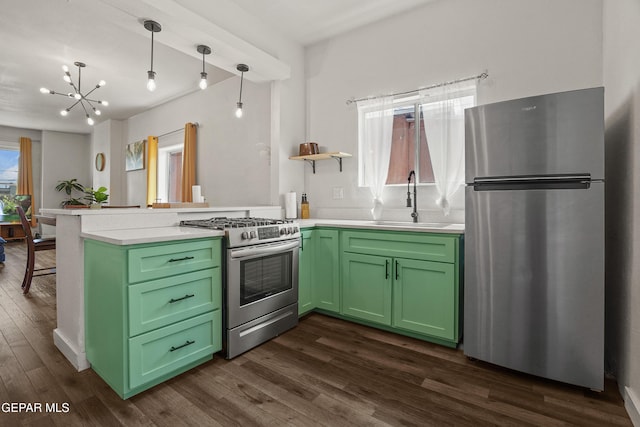 3031 Memphis Ave, El Paso, TX 79930 - kitchen featuring appliances with stainless steel finishes, a peninsula, green cabinets, dark wood finished floors, and light countertops