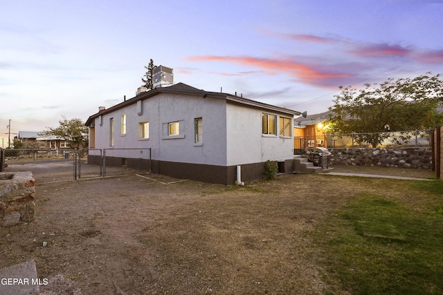 3031 Memphis Ave, El Paso, TX 79930 - view of side of home featuring a gate and stucco siding