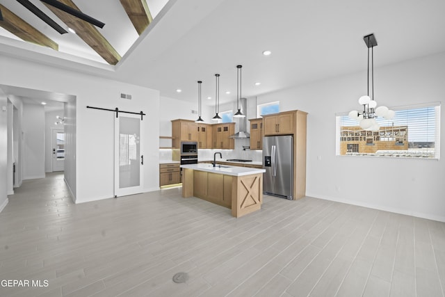 3932 Surmise St, El Paso, TX 79938 - kitchen with stainless steel appliances, a barn door, wall chimney exhaust hood, light countertops, and a chandelier