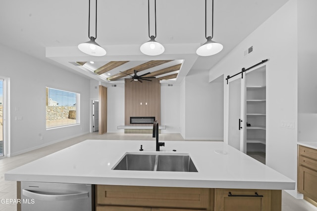 3932 Surmise St, El Paso, TX 79938 - kitchen featuring open floor plan, stainless steel dishwasher, a ceiling fan, light countertops, and a barn door