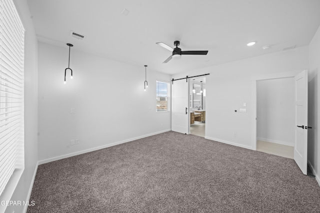 3932 Surmise St, El Paso, TX 79938 - unfurnished bedroom featuring a barn door, carpet floors, and ceiling fan
