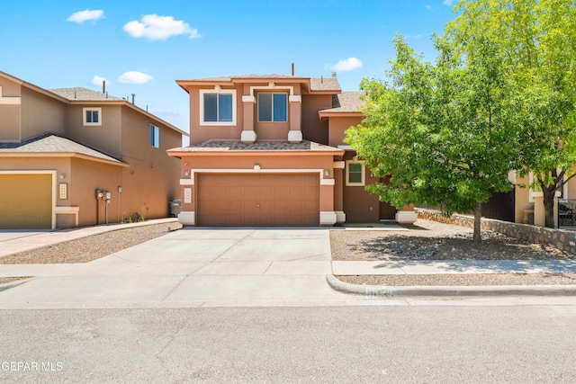 5036 Silver Ranch Ave, El Paso, TX 79934 - view of front facade featuring stucco siding, an attached garage, and driveway