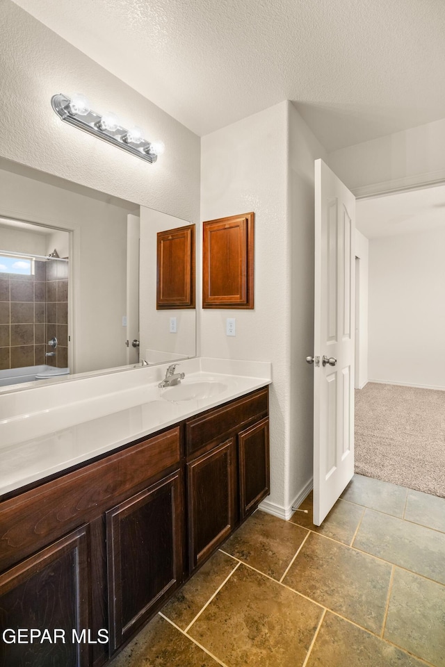 5036 Silver Ranch Ave, El Paso, TX 79934 - bathroom featuring vanity, a textured ceiling, and a shower