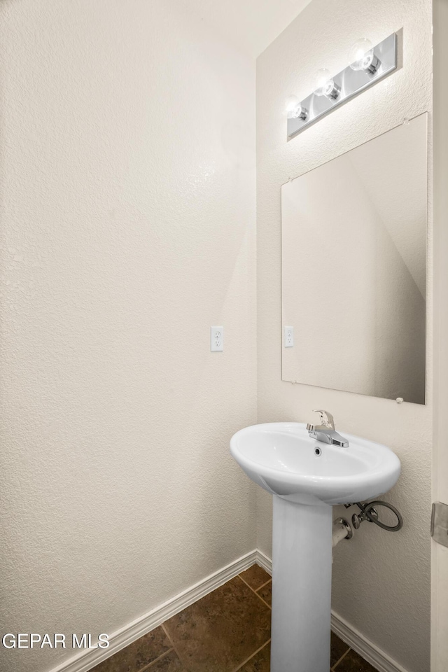 5036 Silver Ranch Ave, El Paso, TX 79934 - bathroom with baseboards and tile patterned flooring