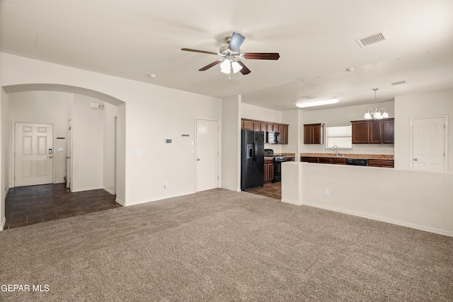 5036 Silver Ranch Ave, El Paso, TX 79934 - unfurnished living room featuring arched walkways, dark colored carpet, and ceiling fan