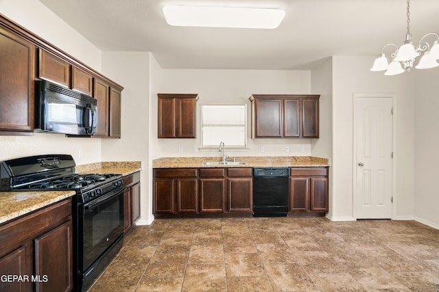 5036 Silver Ranch Ave, El Paso, TX 79934 - kitchen featuring black appliances, a chandelier, dark brown cabinets, light stone counters, and hanging light fixtures