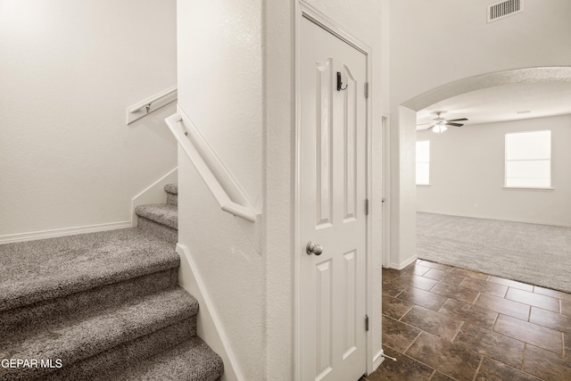 5036 Silver Ranch Ave, El Paso, TX 79934 - staircase featuring carpet floors, a ceiling fan, arched walkways, and stone finish floors