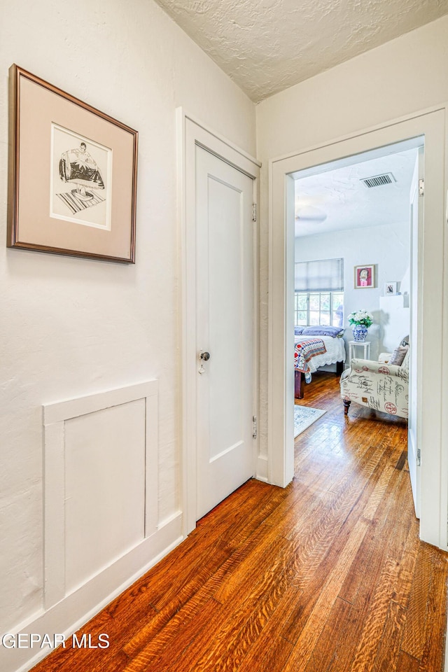 4021 Hastings Dr, El Paso, TX 79903 - hall featuring wood finished floors and a textured ceiling