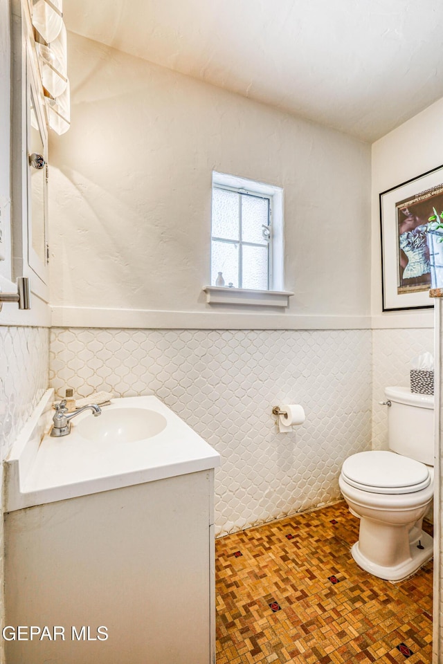 4021 Hastings Dr, El Paso, TX 79903 - bathroom featuring vanity, wainscoting, and tile walls