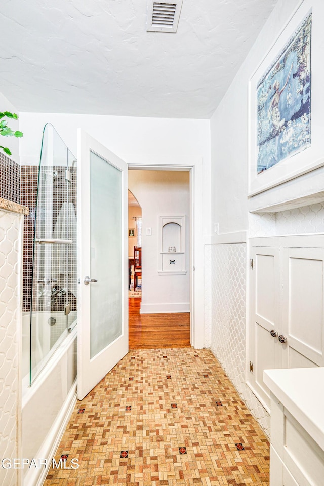4021 Hastings Dr, El Paso, TX 79903 - bathroom with wainscoting, tub / shower combination, and vanity