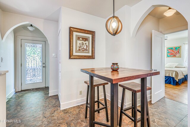 4021 Hastings Dr, El Paso, TX 79903 - dining area featuring stone finish flooring and arched walkways