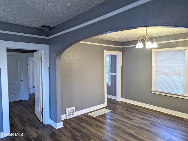 3308 Tularosa Ave, El Paso, TX 79903 - spare room with arched walkways, wood finished floors, a chandelier, and a textured ceiling