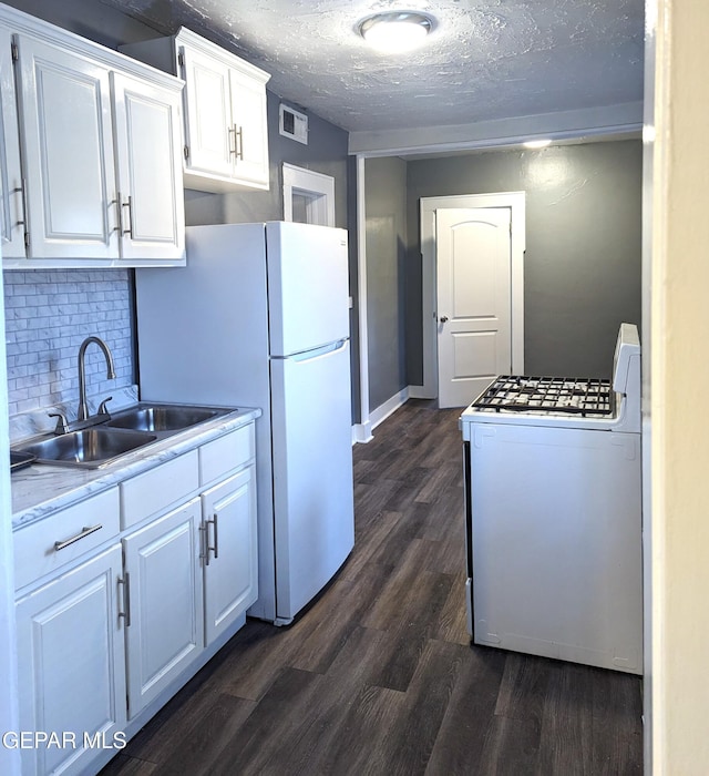 3308 Tularosa Ave, El Paso, TX 79903 - kitchen with white appliances, white cabinetry, dark wood-type flooring, light countertops, and a textured ceiling