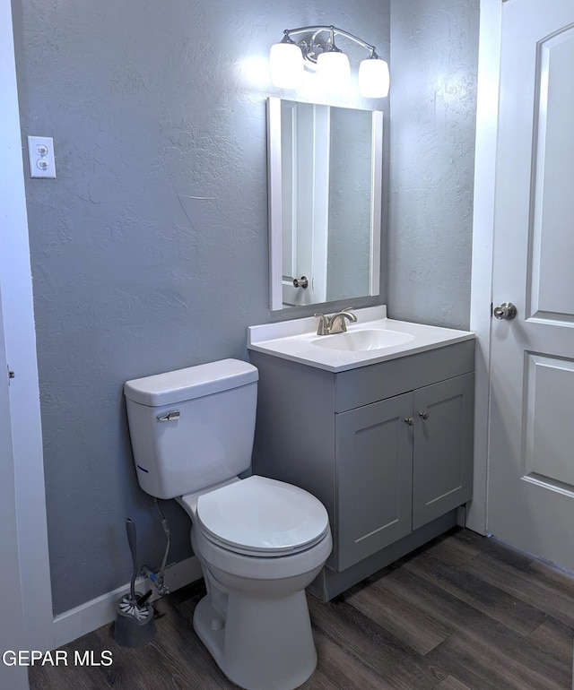 3308 Tularosa Ave, El Paso, TX 79903 - half bathroom with wood finished floors, vanity, and a textured wall