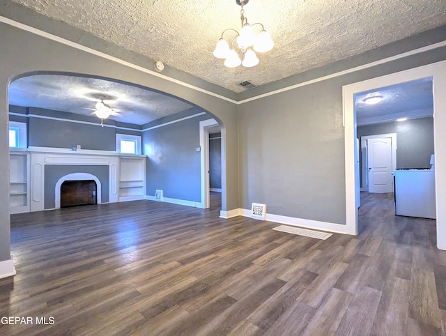 3308 Tularosa Ave, El Paso, TX 79903 - unfurnished living room with arched walkways, a ceiling fan, a fireplace, a chandelier, and dark wood-style flooring