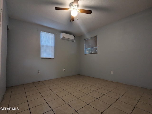 3308 Tularosa Ave, El Paso, TX 79903 - spare room with a wall mounted air conditioner, ceiling fan, and light tile patterned floors