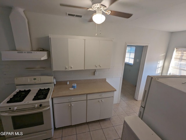 3308 Tularosa Ave, El Paso, TX 79903 - kitchen with white appliances, range hood, light countertops, white cabinets, and light tile patterned floors
