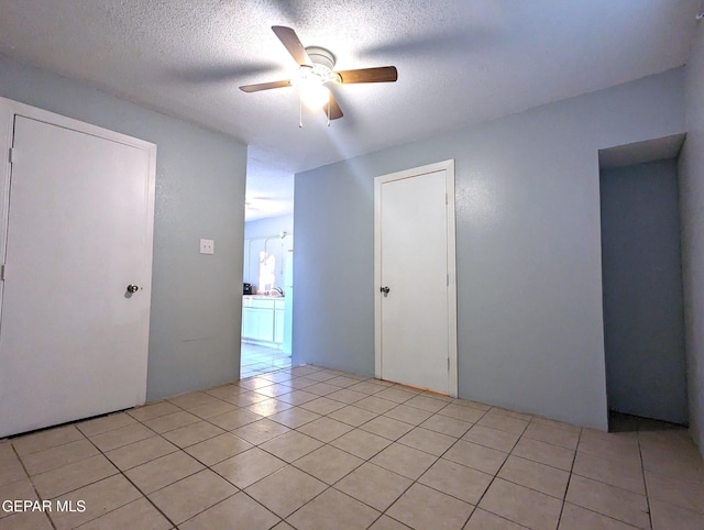 3308 Tularosa Ave, El Paso, TX 79903 - unfurnished room featuring a ceiling fan, light tile patterned flooring, and a textured ceiling