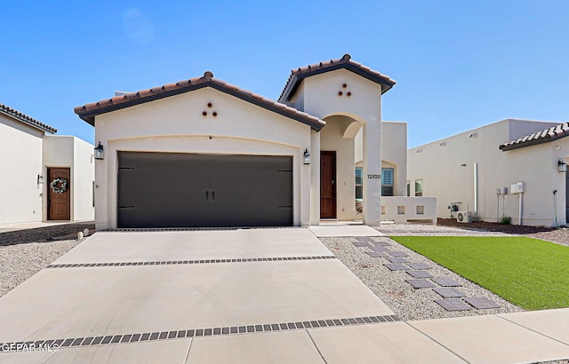 12820 Monmouth Ave, El Paso, TX 79928 - mediterranean / spanish home with an attached garage, concrete driveway, stucco siding, and a tile roof
