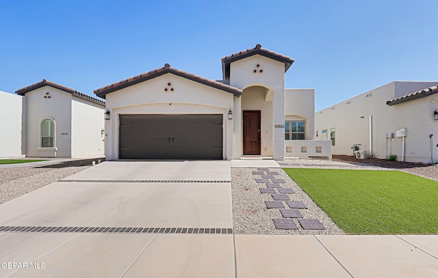 12820 Monmouth Ave, El Paso, TX 79928 - mediterranean / spanish-style house with driveway, an attached garage, a tile roof, and stucco siding