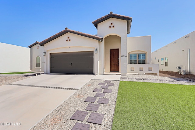 12820 Monmouth Ave, El Paso, TX 79928 - mediterranean / spanish-style house with a tile roof, stucco siding, a garage, concrete driveway, and a front lawn