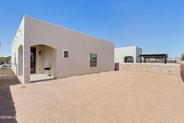 12820 Monmouth Ave, El Paso, TX 79928 - back of property with stucco siding and a patio area
