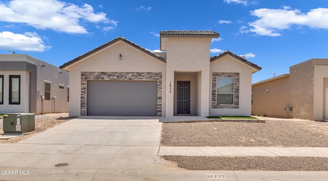 14772 John Mcneely Ave, El Paso, TX 79938 - view of front facade featuring driveway, stone siding, a garage, and stucco siding