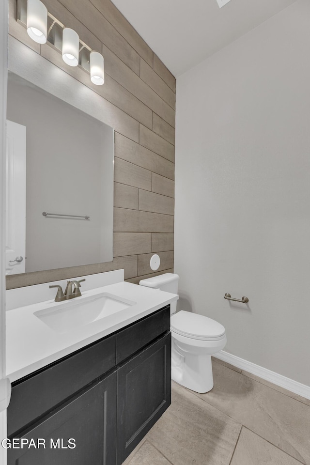 14772 John Mcneely Ave, El Paso, TX 79938 - bathroom featuring vanity, wooden walls, an accent wall, and tile patterned flooring
