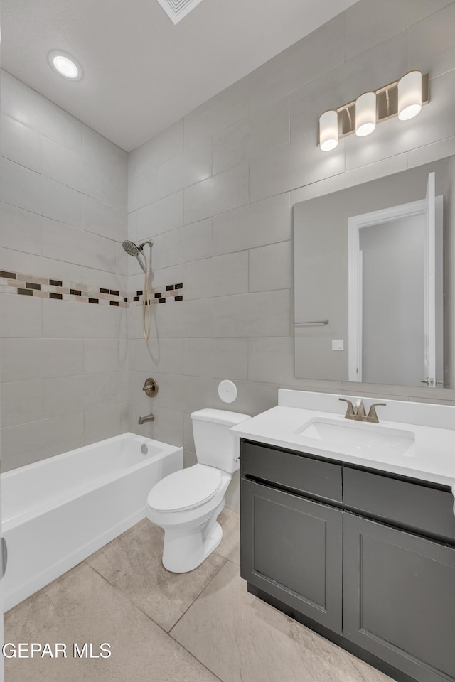 14772 John Mcneely Ave, El Paso, TX 79938 - full bath featuring vanity, tile patterned floors, shower / washtub combination, and tile walls