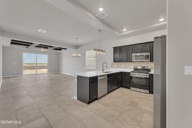 14772 John Mcneely Ave, El Paso, TX 79938 - kitchen featuring appliances with stainless steel finishes, tasteful backsplash, recessed lighting, open floor plan, and light countertops