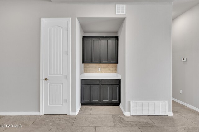 14772 John Mcneely Ave, El Paso, TX 79938 - bar featuring backsplash and light tile patterned floors