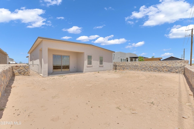 14772 John Mcneely Ave, El Paso, TX 79938 - rear view of house featuring stucco siding and a fenced backyard