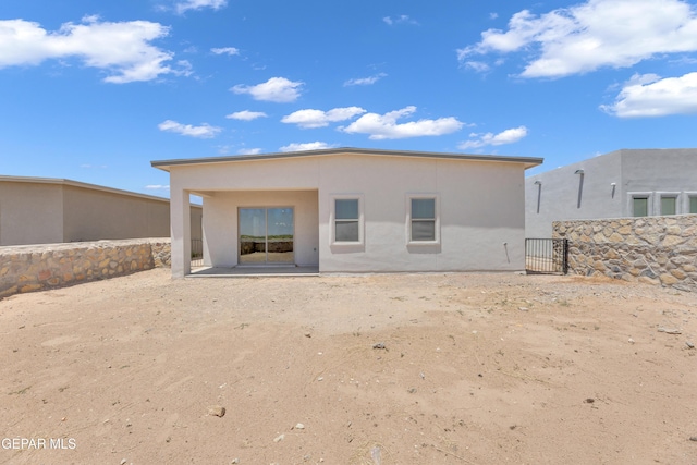 14772 John Mcneely Ave, El Paso, TX 79938 - rear view of property with stucco siding and a patio
