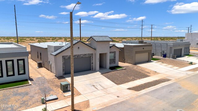 14772 John Mcneely Ave, El Paso, TX 79938 - view of front facade featuring stucco siding, driveway, and a tiled roof