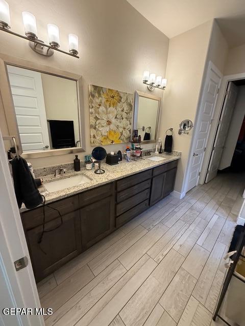 2313 Dancing Piper Way, El Paso, TX 79911 - bathroom featuring double vanity and wood finished floors