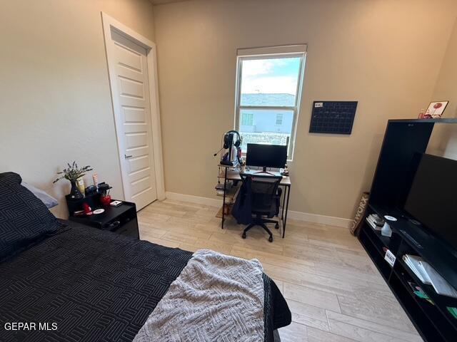 2313 Dancing Piper Way, El Paso, TX 79911 - bedroom with light wood-style flooring and a desk