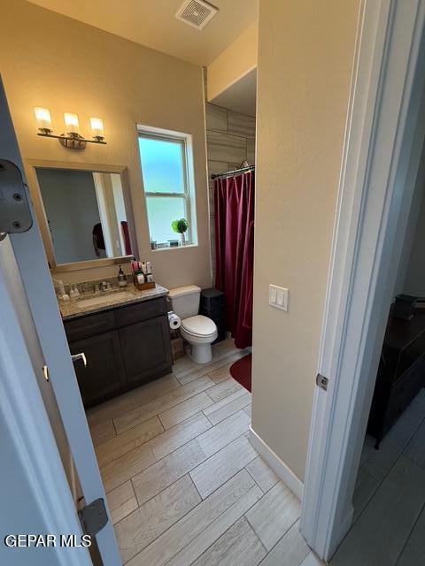 2313 Dancing Piper Way, El Paso, TX 79911 - bathroom with vanity, wood finish floors, and a shower with shower curtain