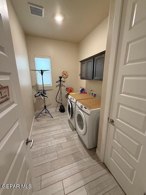 2313 Dancing Piper Way, El Paso, TX 79911 - laundry area featuring cabinet space, independent washer and dryer, and wood tiled floors