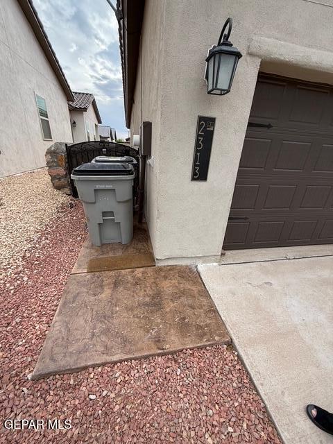 2313 Dancing Piper Way, El Paso, TX 79911 - view of side of property with stucco siding and a garage