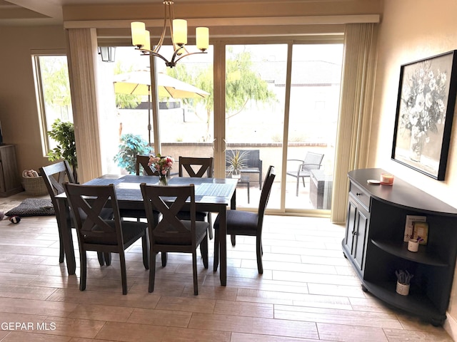 2313 Dancing Piper Way, El Paso, TX 79911 - dining room featuring a chandelier, healthy amount of natural light, and light wood finished floors