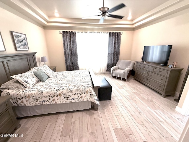 2313 Dancing Piper Way, El Paso, TX 79911 - bedroom featuring a tray ceiling, light wood finished floors, and ceiling fan