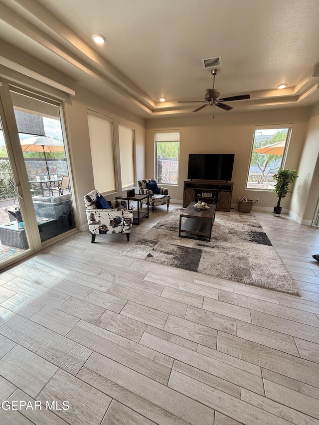 2313 Dancing Piper Way, El Paso, TX 79911 - living room with a tray ceiling, wood finished floors, recessed lighting, and ceiling fan
