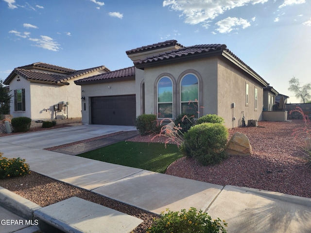 2313 Dancing Piper Way, El Paso, TX 79911 - mediterranean / spanish home featuring stucco siding, a garage, concrete driveway, and a tile roof