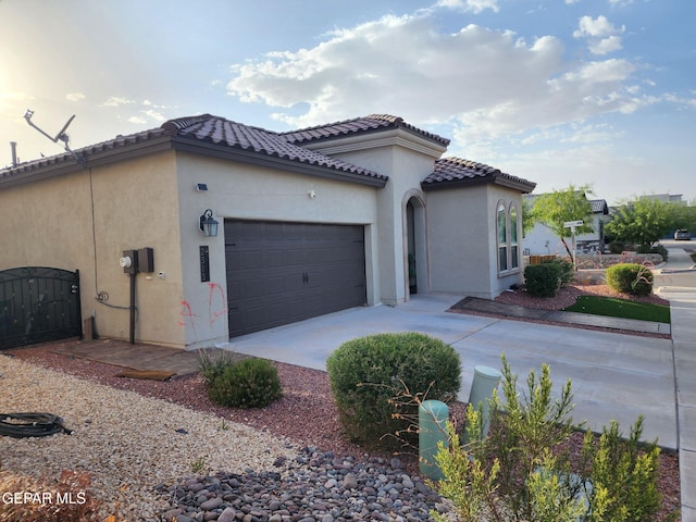 2313 Dancing Piper Way, El Paso, TX 79911 - view of side of property with an attached garage, stucco siding, driveway, and a tile roof