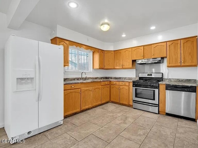 3305 Killarney St, El Paso, TX 79925 - kitchen with appliances with stainless steel finishes, ventilation hood, brown cabinets, and recessed lighting