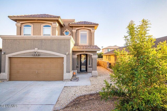 5004 Gold Ranch Ave, El Paso, TX 79934 - mediterranean / spanish-style home with a tile roof, stucco siding, driveway, and an attached garage