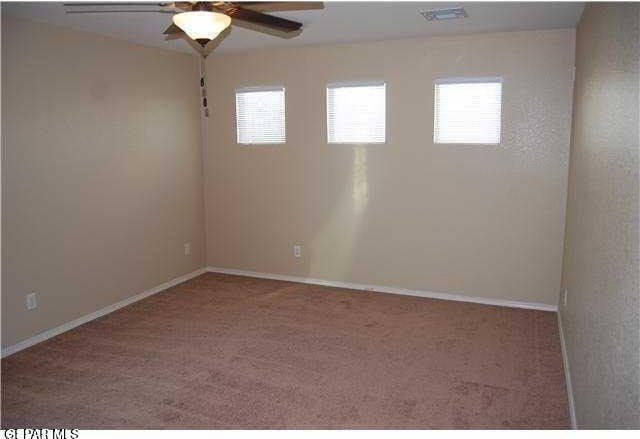 5004 Gold Ranch Ave, El Paso, TX 79934 - empty room with plenty of natural light, a ceiling fan, and carpet