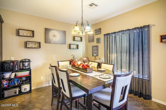 5004 Gold Ranch Ave, El Paso, TX 79934 - dining room with a chandelier and dark tile patterned floors