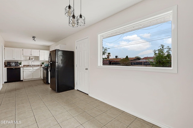 4956 Rutherford Dr, El Paso, TX 79924 - kitchen with black appliances, white cabinetry, light tile patterned flooring, hanging light fixtures, and light countertops