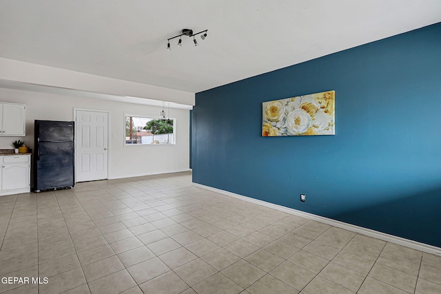 4956 Rutherford Dr, El Paso, TX 79924 - spare room featuring light tile patterned floors and an accent wall